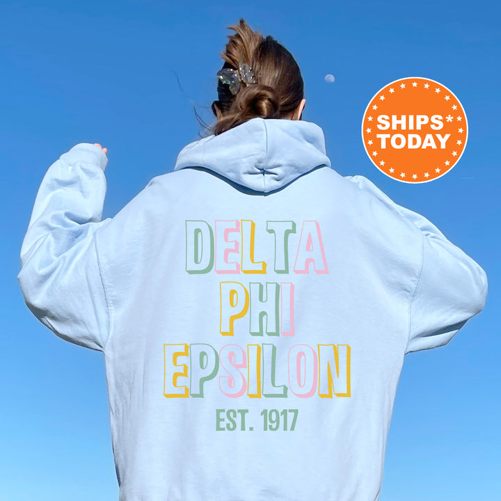 a woman wearing a white hoodie with the words delta phi epiloon printed