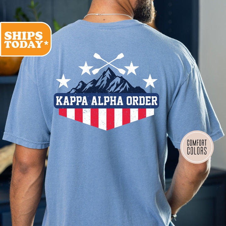 a man wearing a blue shirt with the words kappa alpha order on