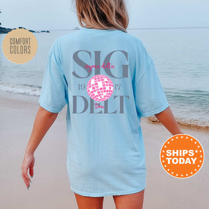 a woman walking on the beach with a t - shirt on