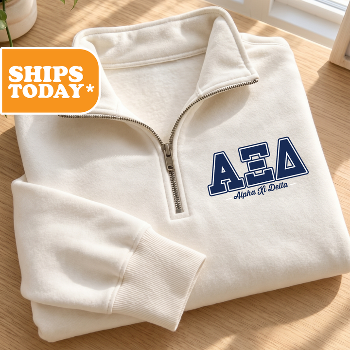 A white zip-up jacket with the letters 'AEA' printed on it, placed on a wooden surface.