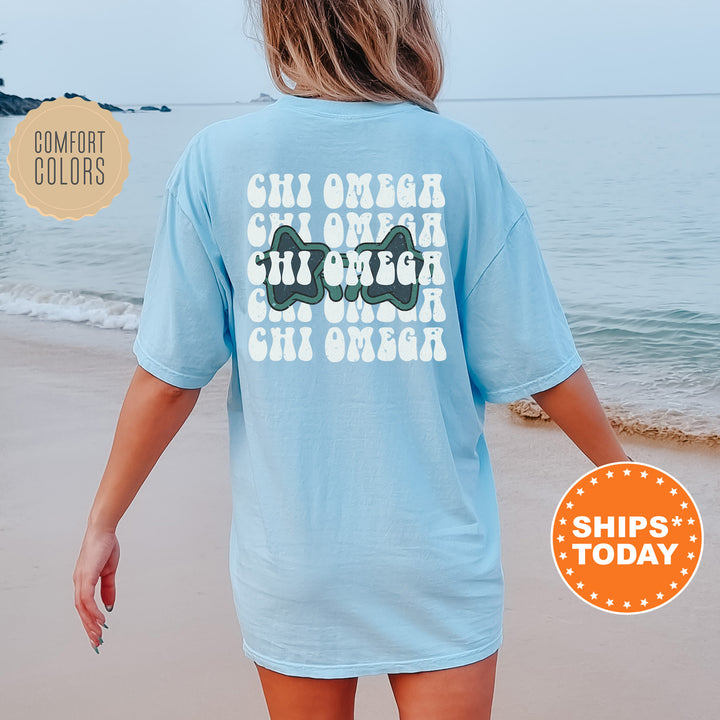 a woman walking on the beach wearing a blue shirt