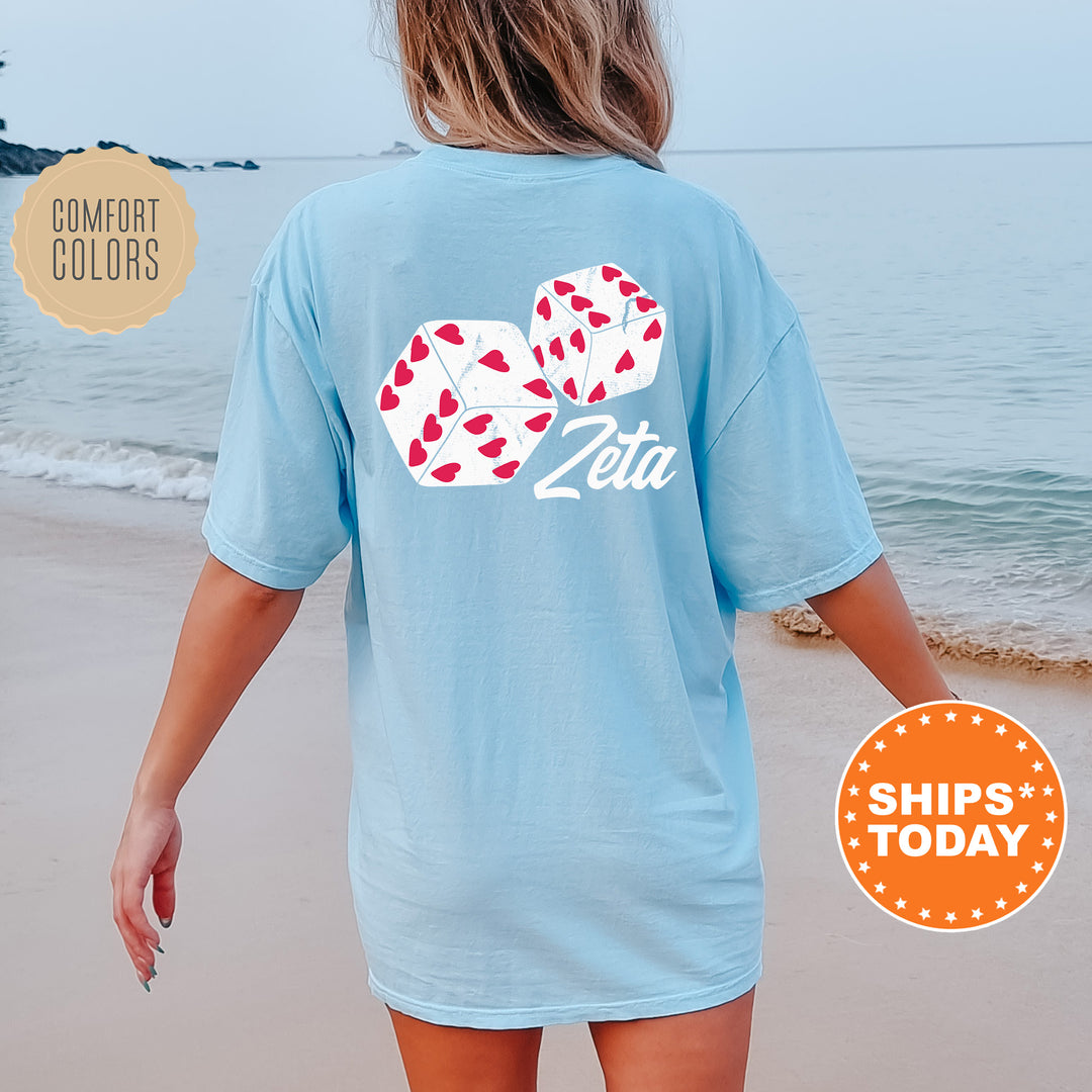 a woman walking on the beach wearing a blue shirt