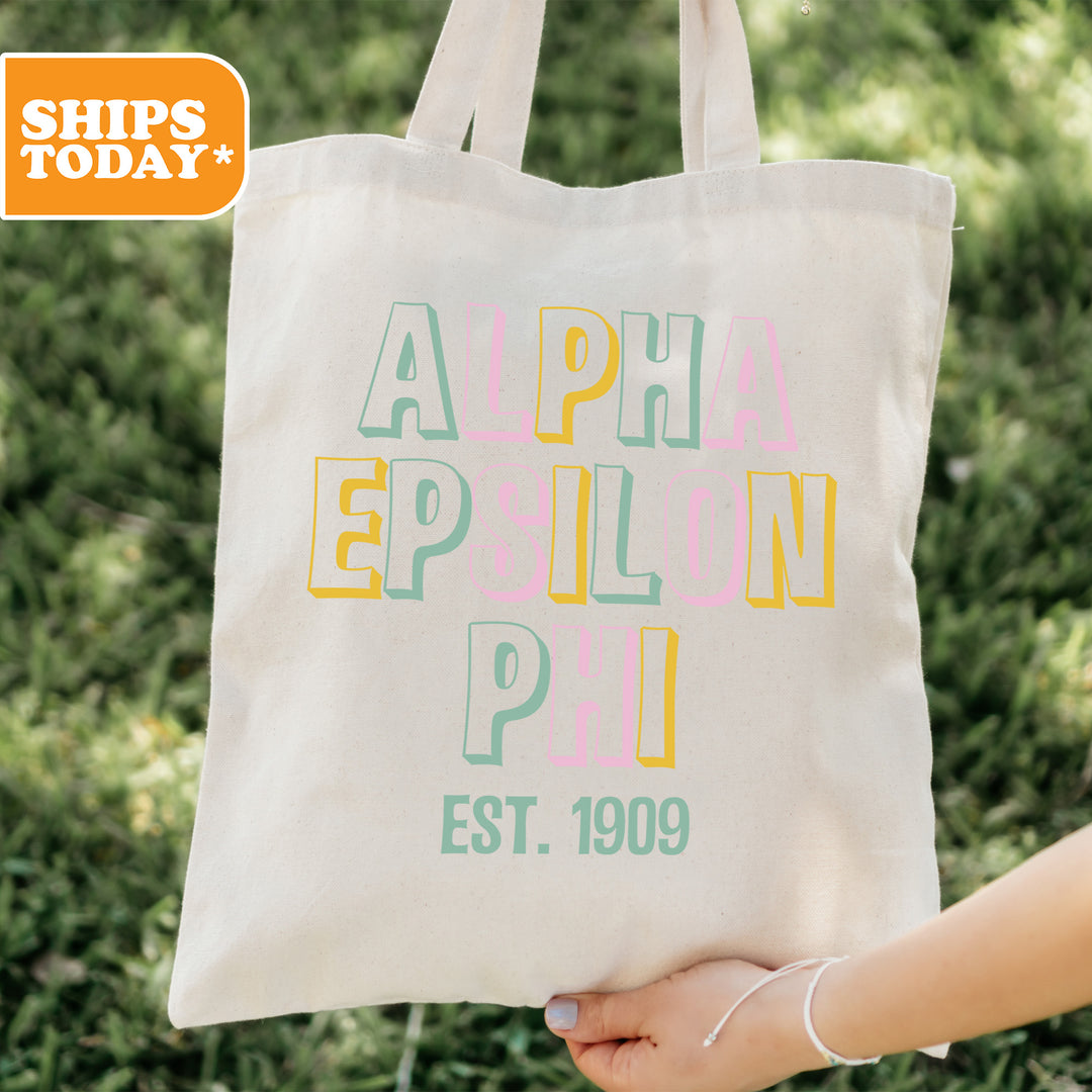 a person holding a tote bag in their hand