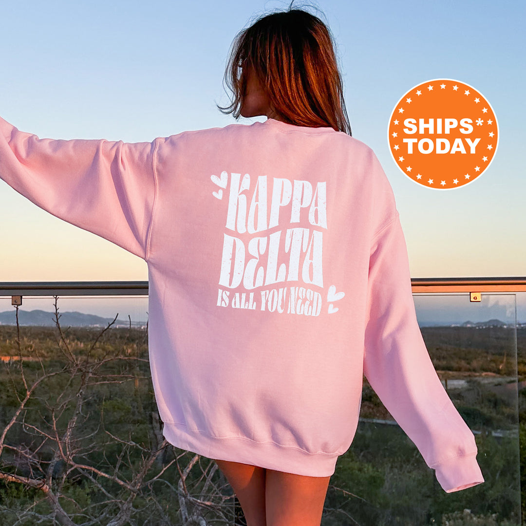 a woman wearing a pink sweatshirt with the words kapppa delta printed on it