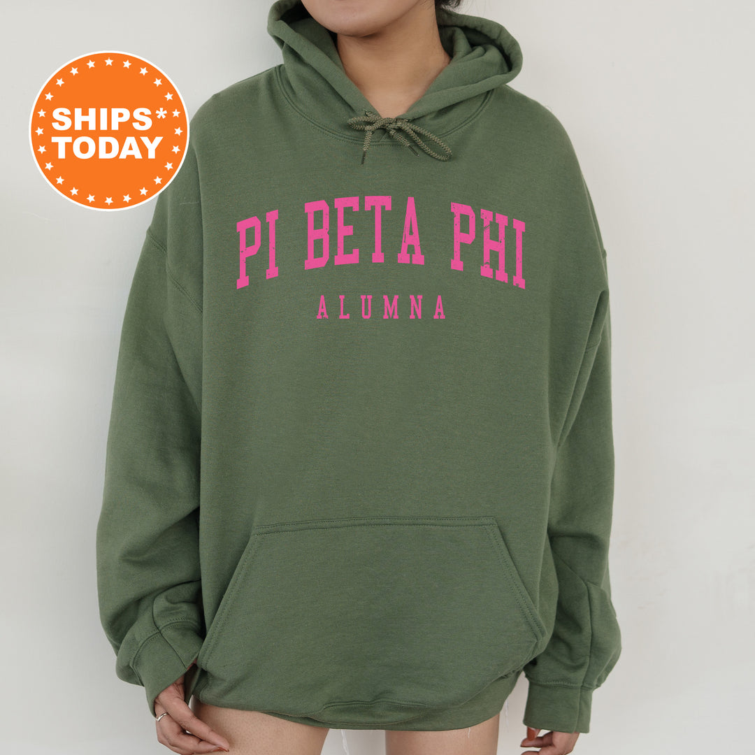 a woman wearing a green hoodie with pink letters on it