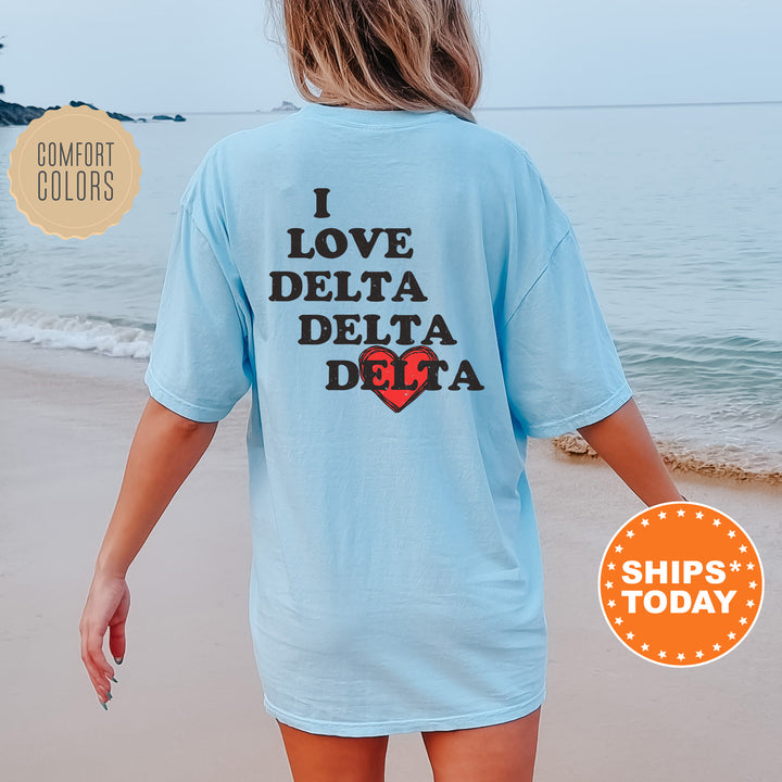 a woman walking on the beach wearing a t - shirt that says i love delta