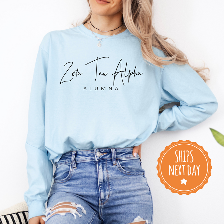 a woman wearing a light blue sweatshirt with the words eat to the altar on it