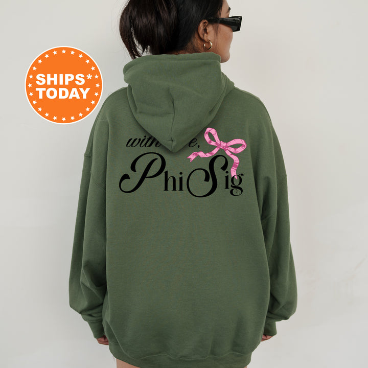 a woman wearing a green hoodie with a pink bow on it