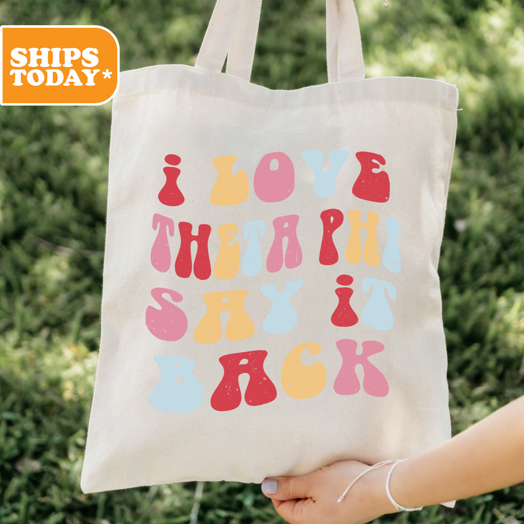 a person holding a tote bag with the words love, therapy, and sex