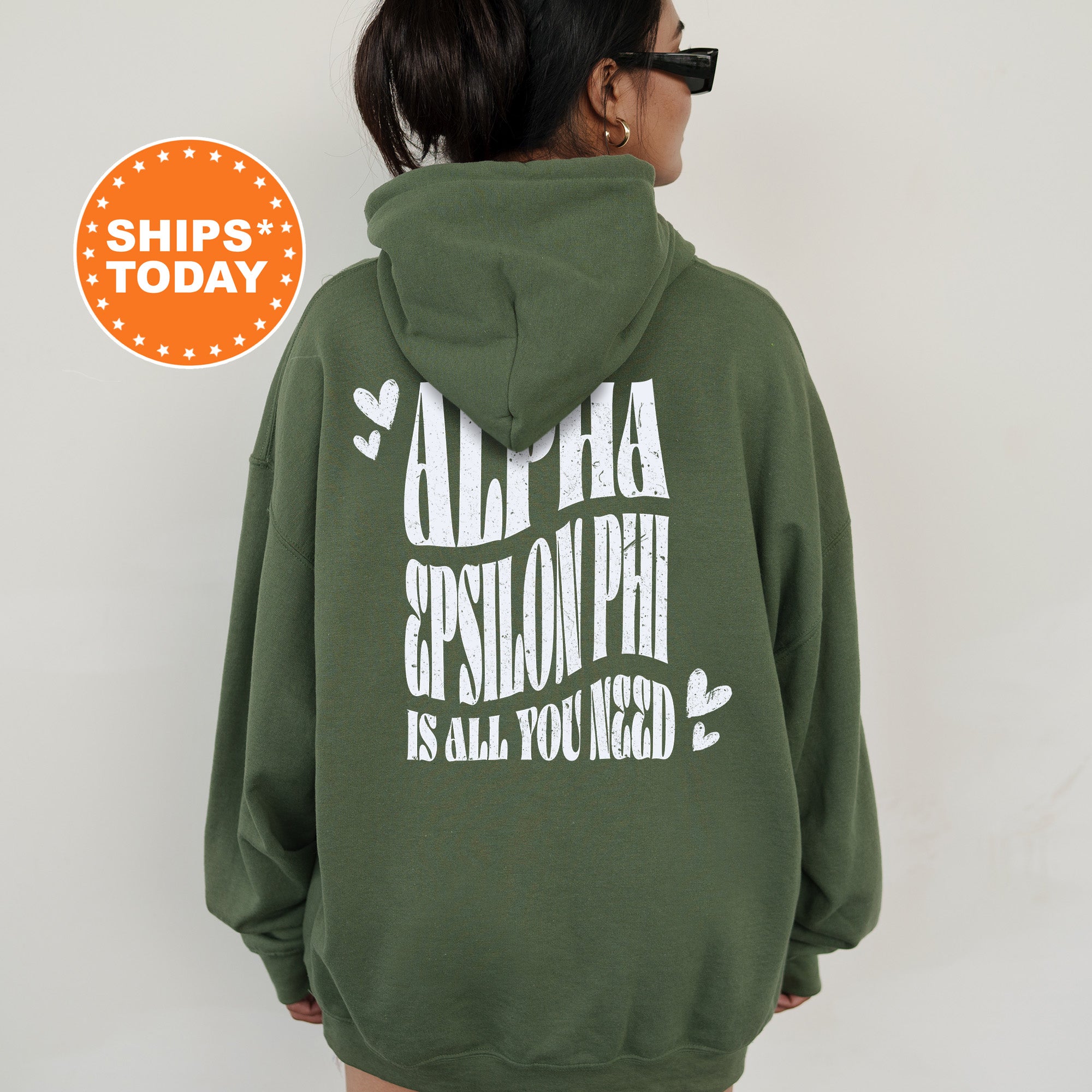 a woman wearing a green hoodie with white lettering