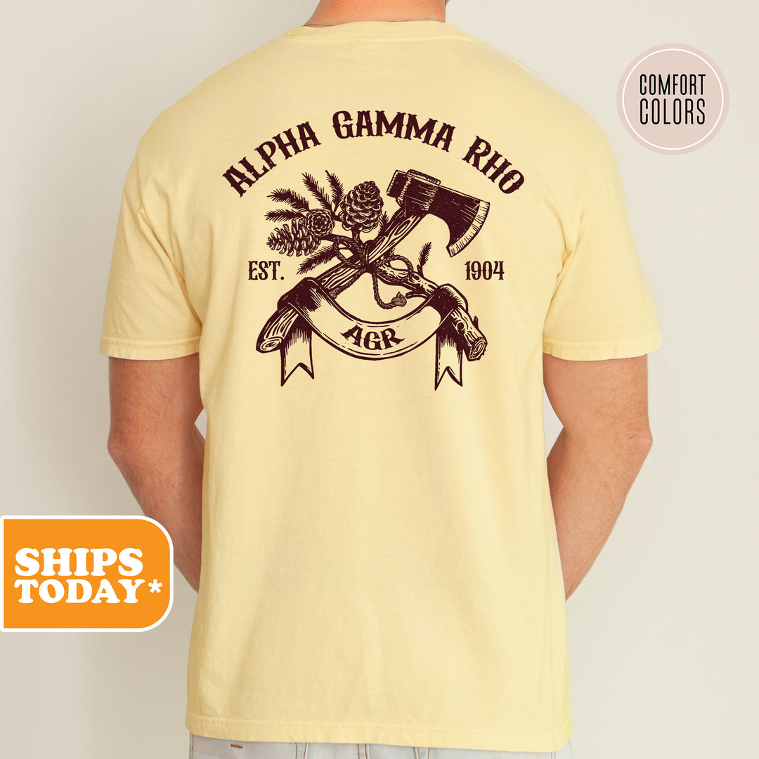 a man wearing a yellow t - shirt with an image of a hammer and pine