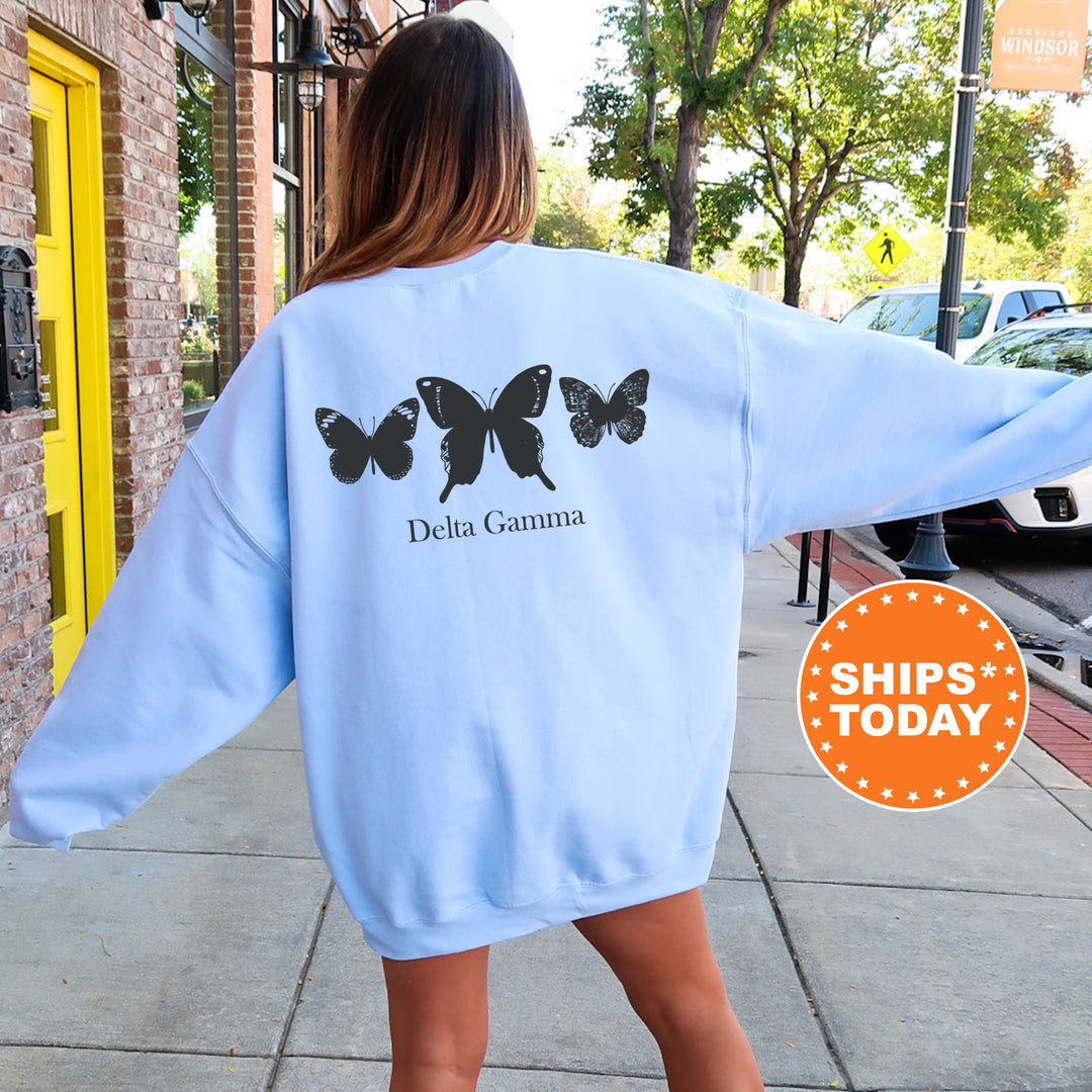 a woman walking down a sidewalk wearing a blue sweatshirt