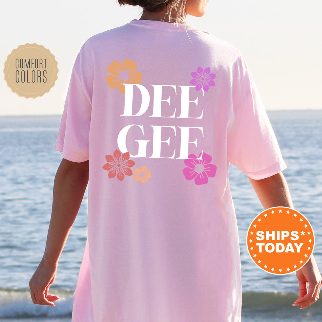 a woman wearing a pink shirt that says dee gee