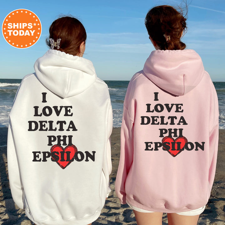 two women wearing matching sweatshirts on the beach