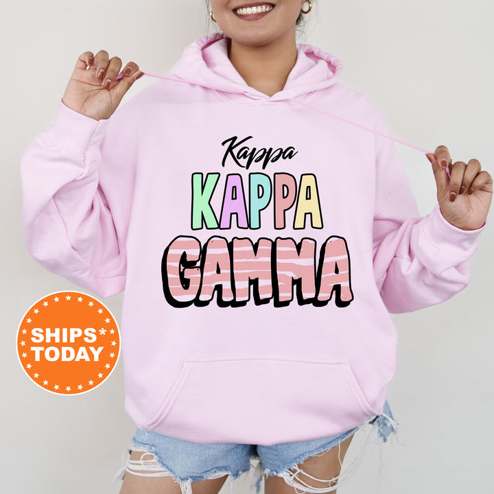 a woman wearing a pink hoodie that says kappa kappa ga