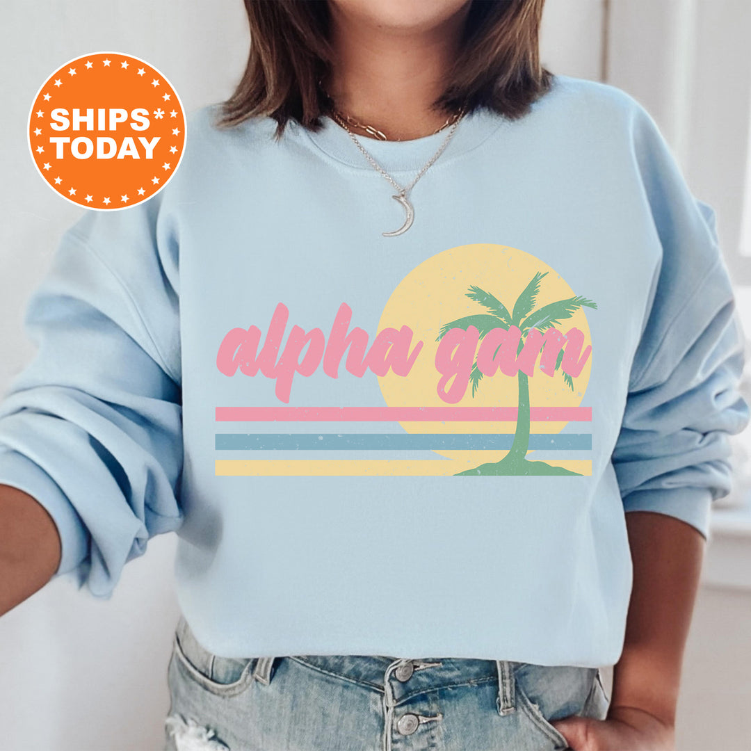 a woman wearing a blue sweatshirt with a palm tree on it