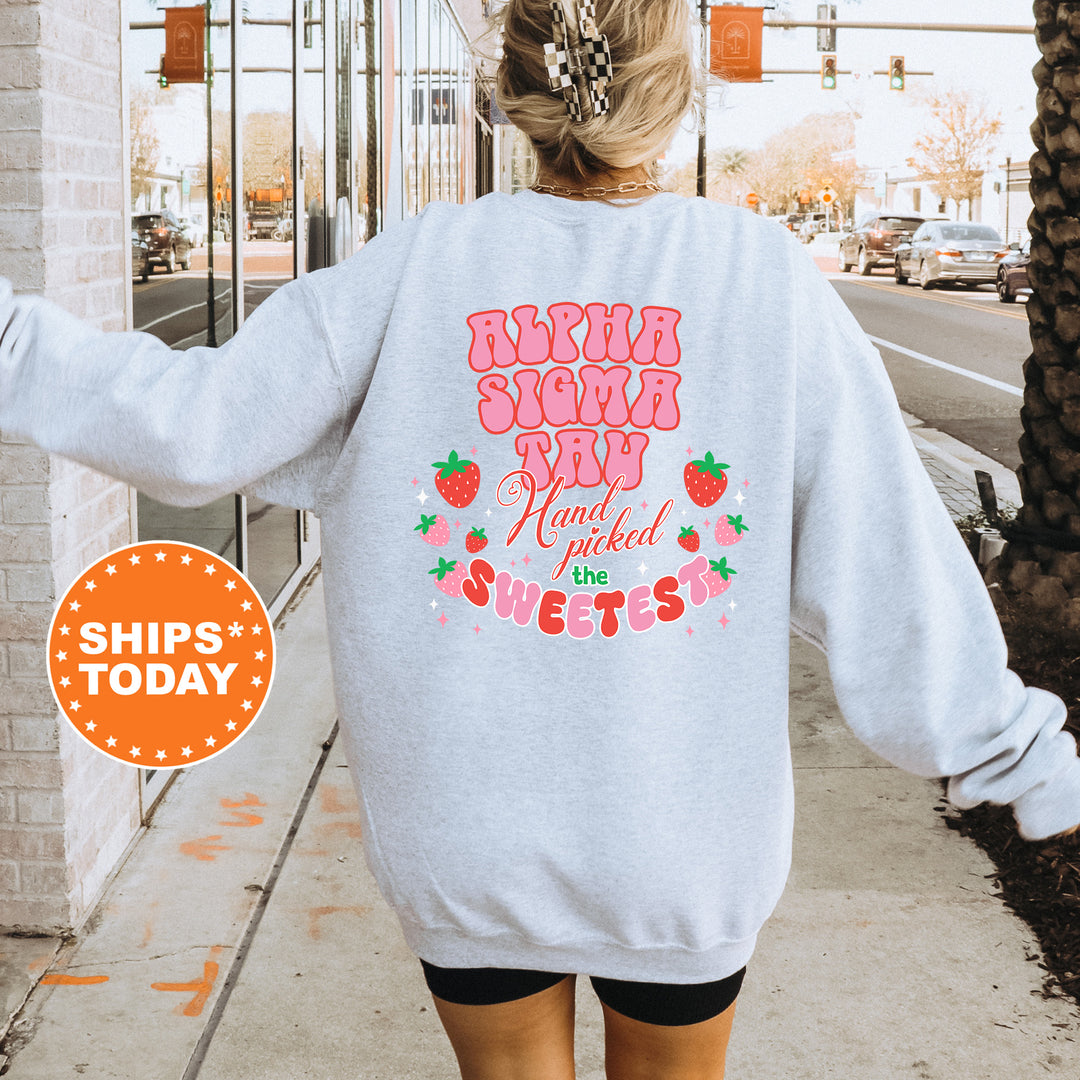 a woman walking down a sidewalk wearing a sweatshirt