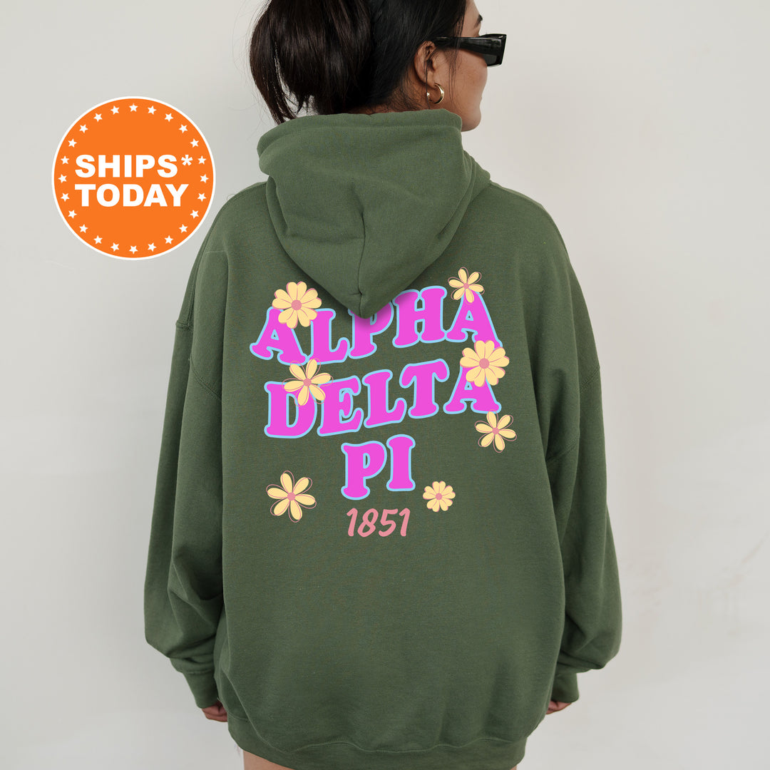 A person wearing a green hoodie with the text "ALPHA DELTA PI 1851" printed on it.