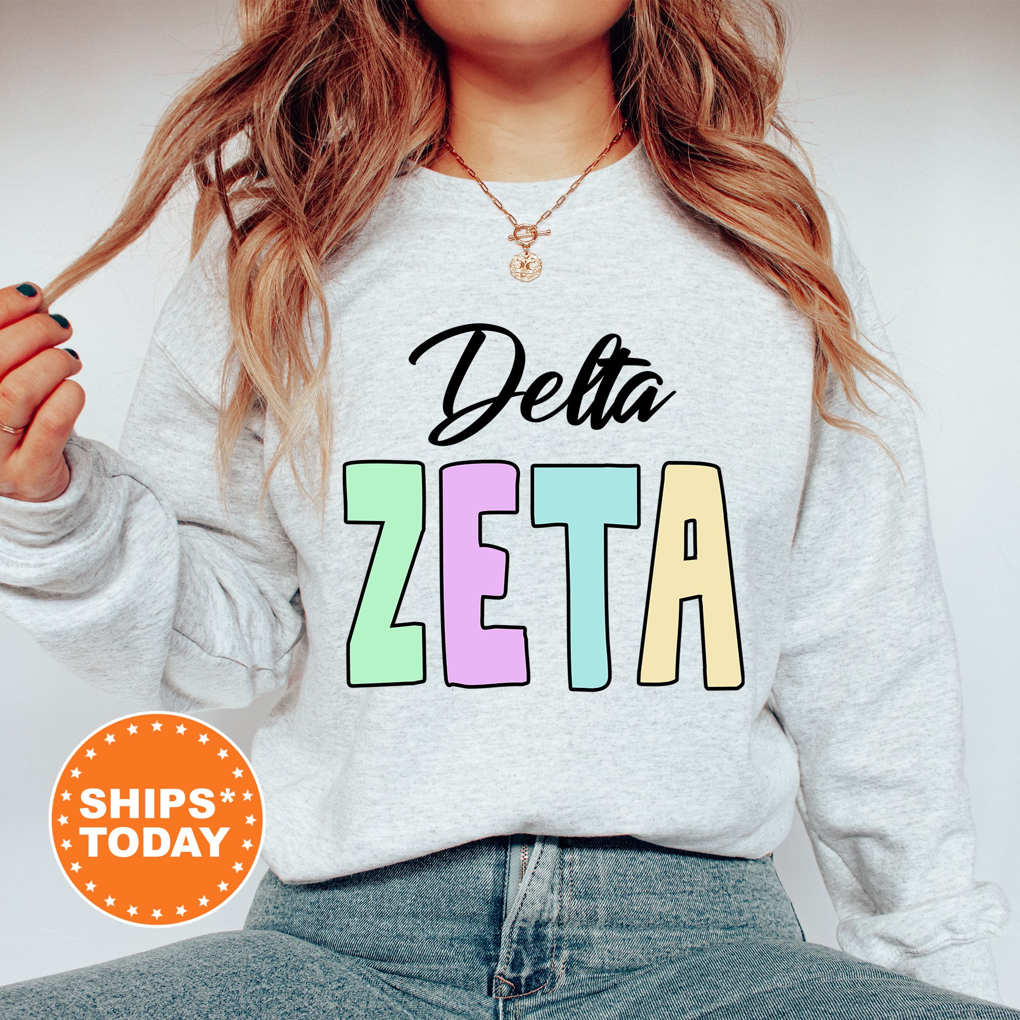 a woman wearing a sweatshirt that says delta zeta