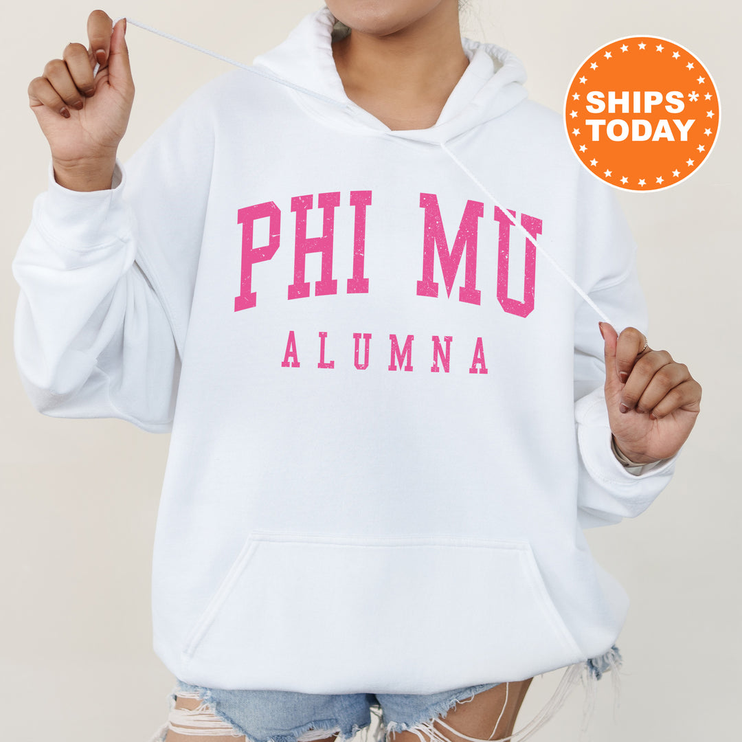 a woman wearing a white hoodie with pink letters on it