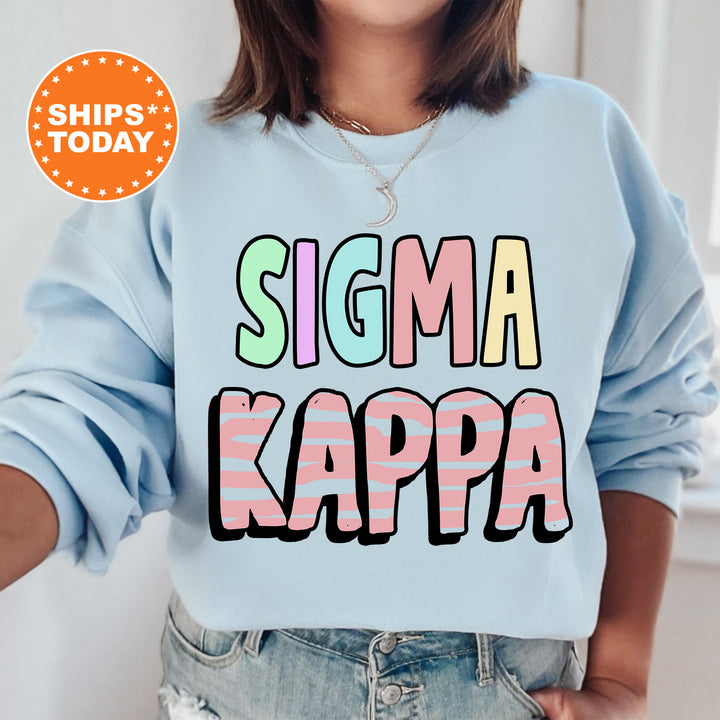 a woman wearing a blue sweatshirt that says stigmaa kappa