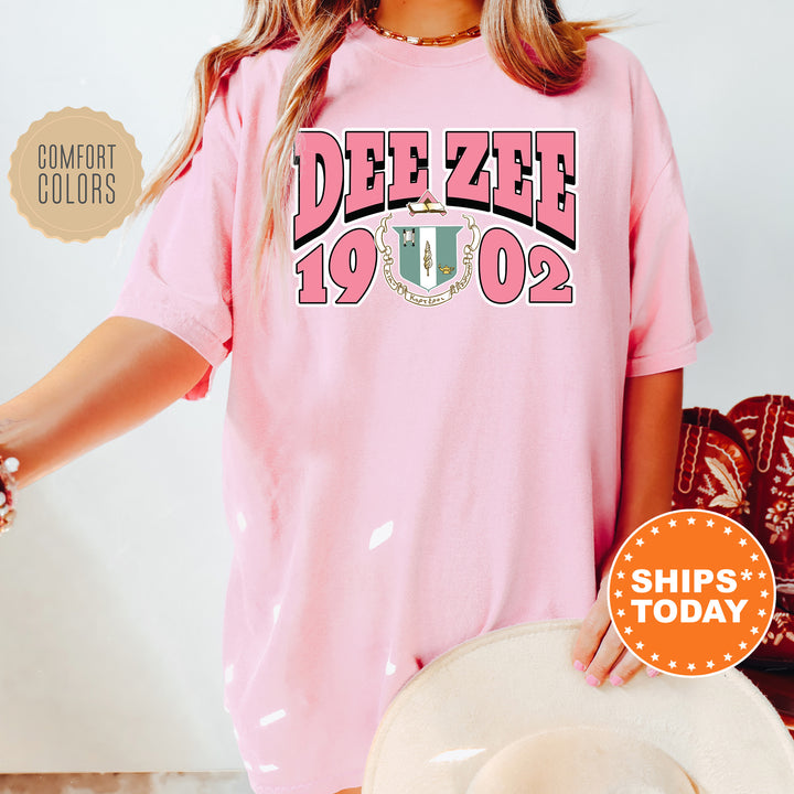 a woman wearing a pink tee shirt with the words dee zeee on it