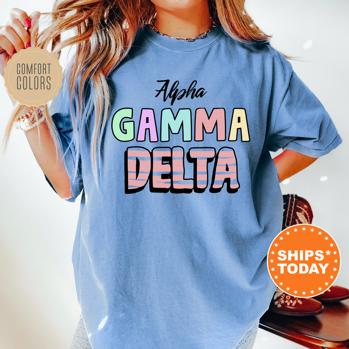 a woman wearing a blue shirt with the words gama delta on it