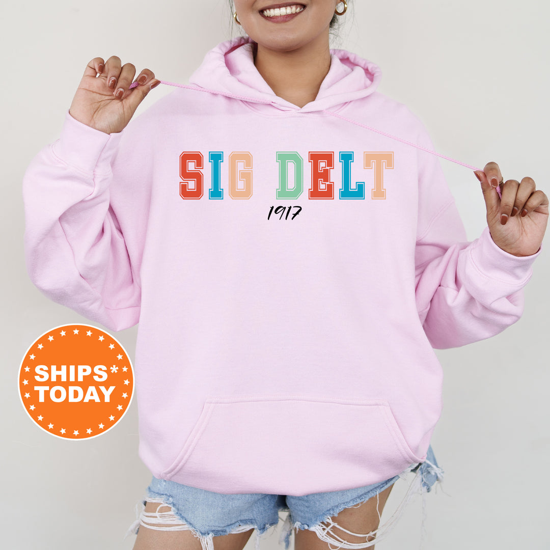 a woman wearing a pink hoodie with the word sig delt on it