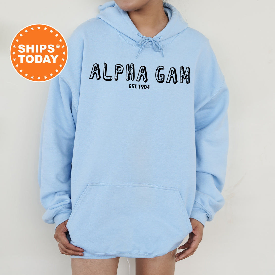 a woman wearing a light blue hoodie with the word alphigan on it