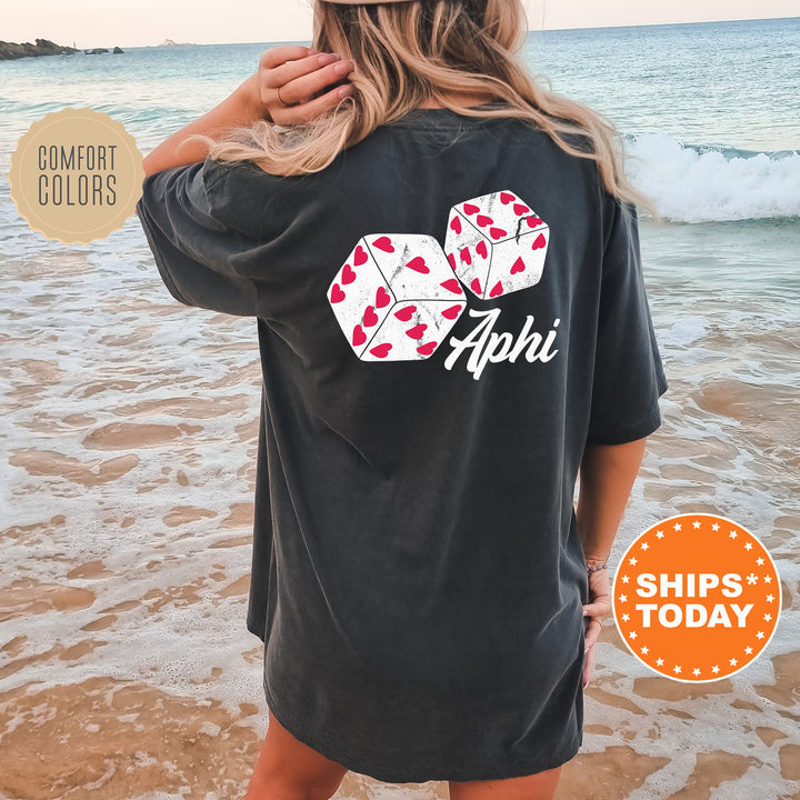 a woman standing on a beach wearing a black shirt