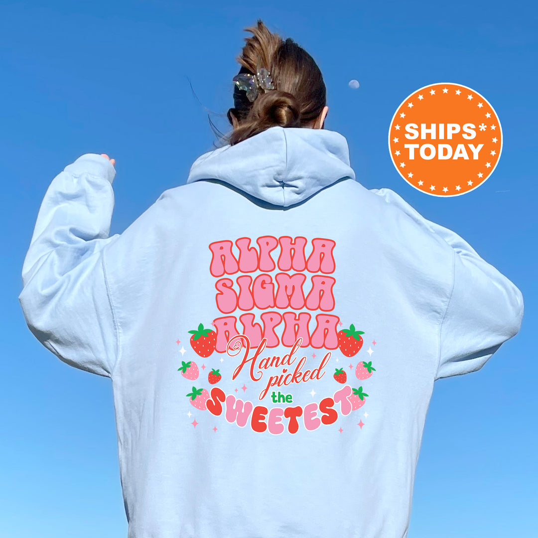 a woman wearing a white hoodie with a strawberry print on it
