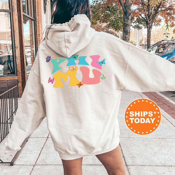 a woman walking down a sidewalk wearing a white hoodie
