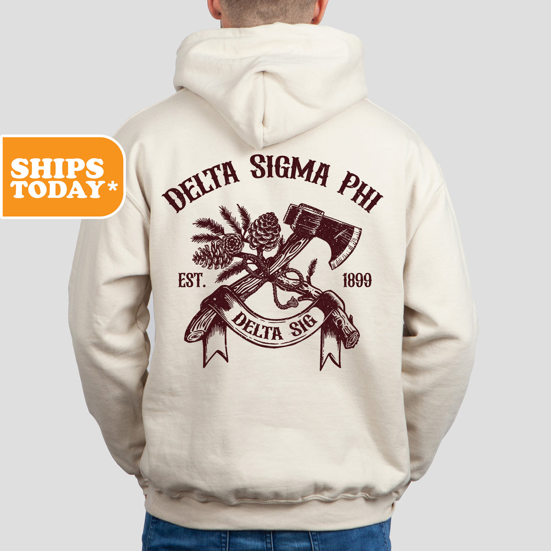 a man wearing a white hoodie with a hammer and a skull on it