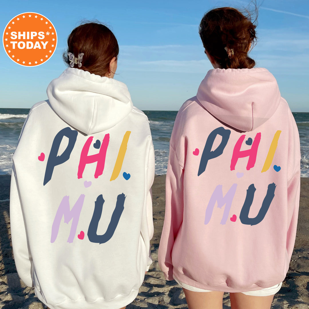 two girls in matching sweatshirts on the beach