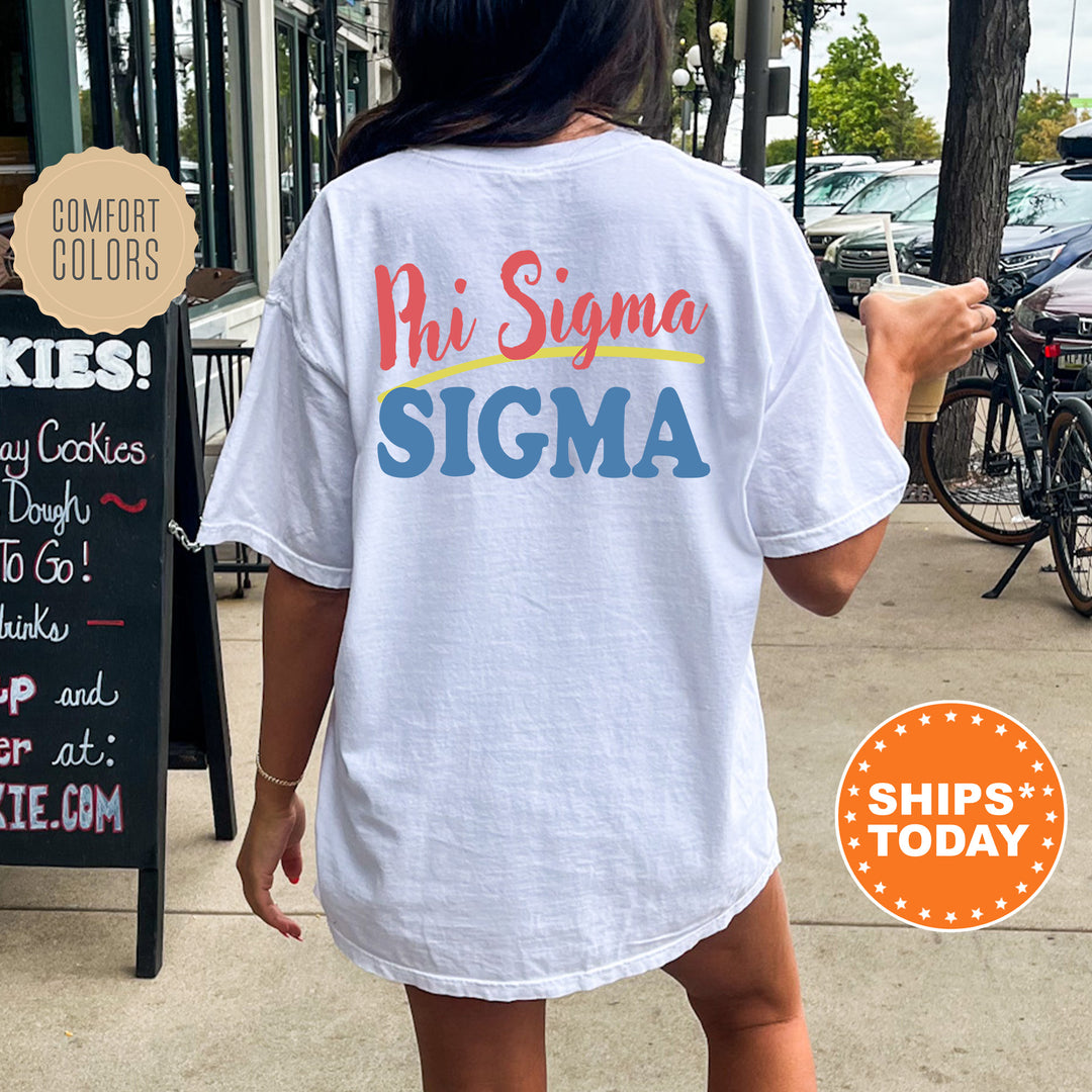 A person wearing a white t-shirt with the text "Phi Sigma Sigma" printed on it, standing on a sidewalk next to a chalkboard sign.