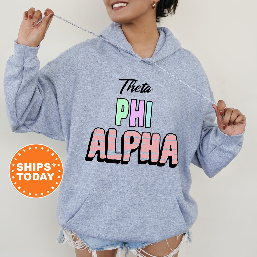 a woman wearing a blue sweatshirt with the word phi alphia printed on it