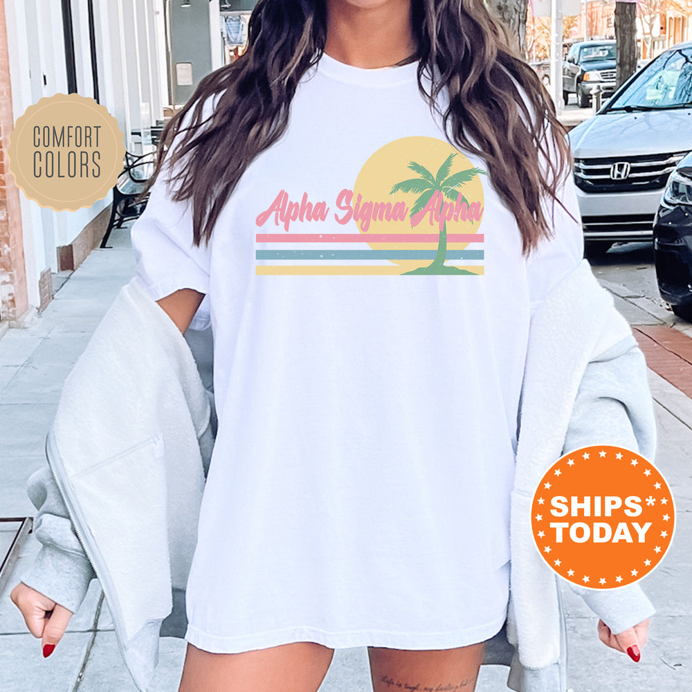 a woman wearing a white shirt with a palm tree on it