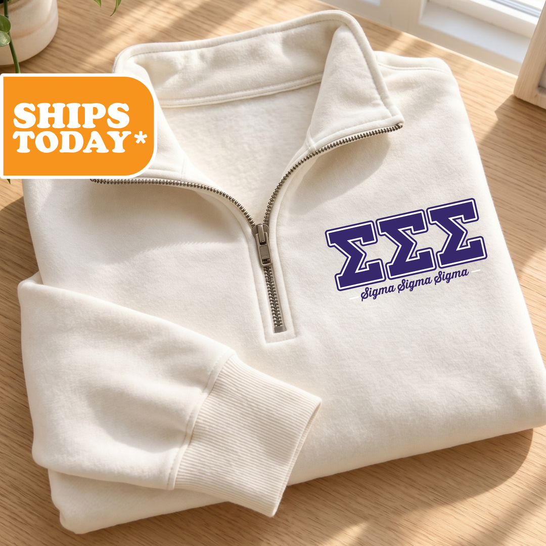 A white zip-up jacket with a Sigma Sigma Sigma logo on the left chest area, placed on a wooden surface.