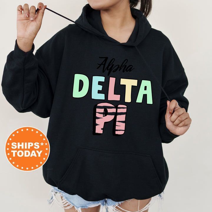 a woman wearing a black delta hoodie with the delta on it