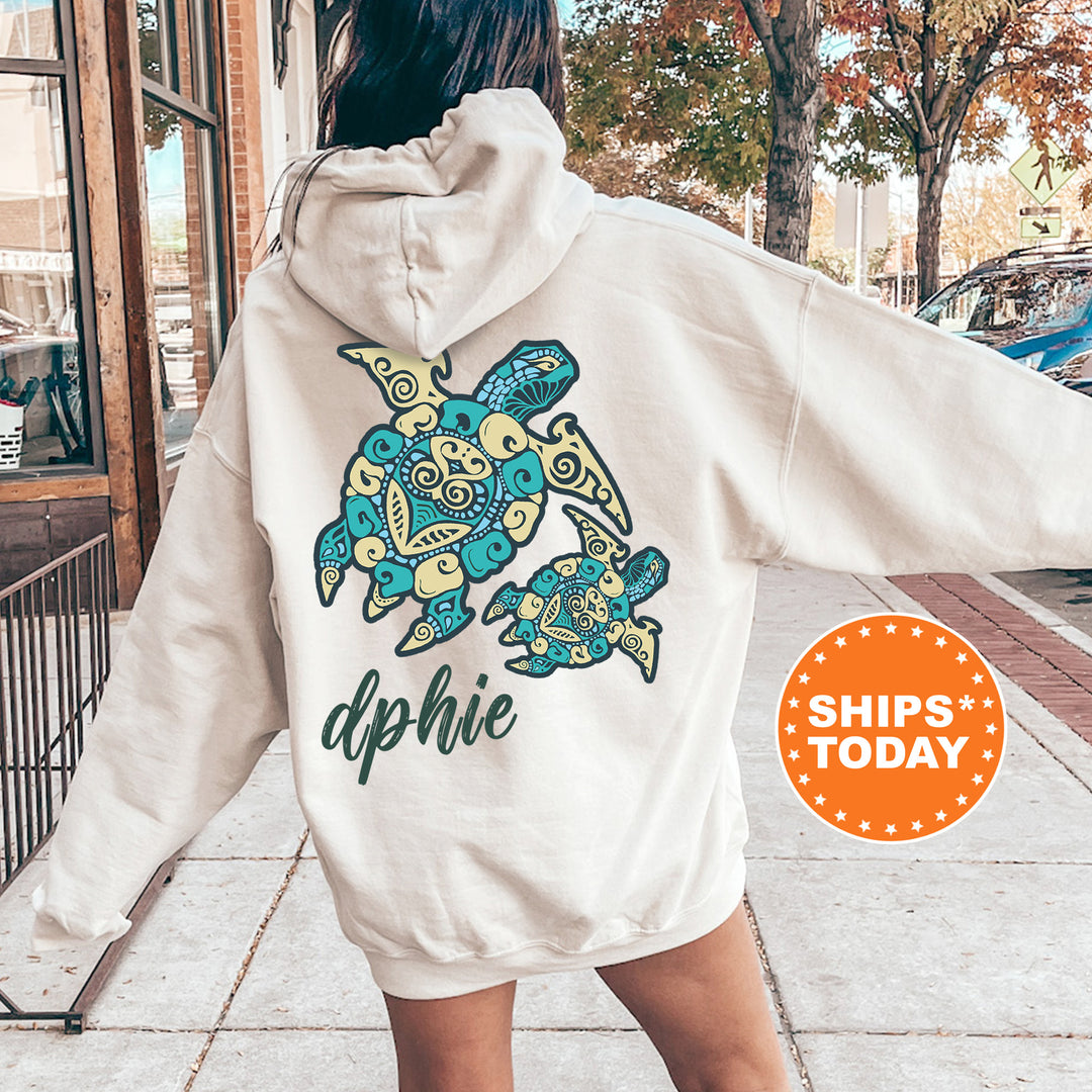 A person wearing a white hoodie with a colorful turtle design on the back, standing on a sidewalk.