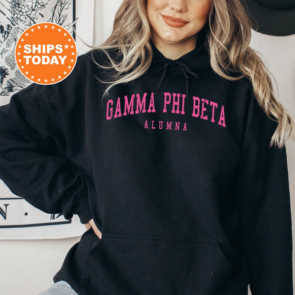 a woman wearing a black hoodie with pink letters