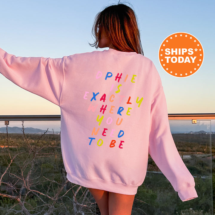 a woman wearing a pink sweatshirt with words written on it