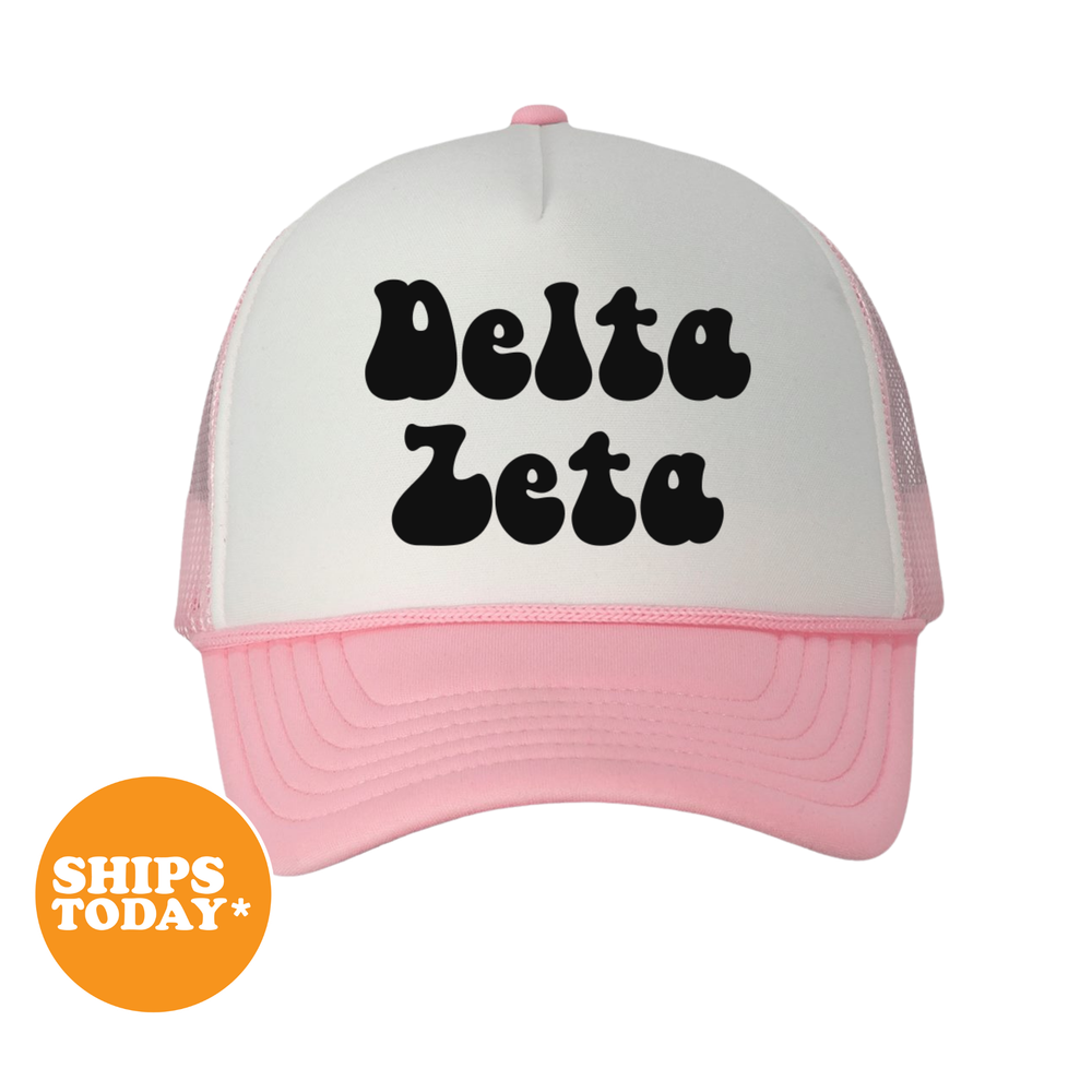 A white and pink baseball cap with the text "Delta Zeta" printed on it.