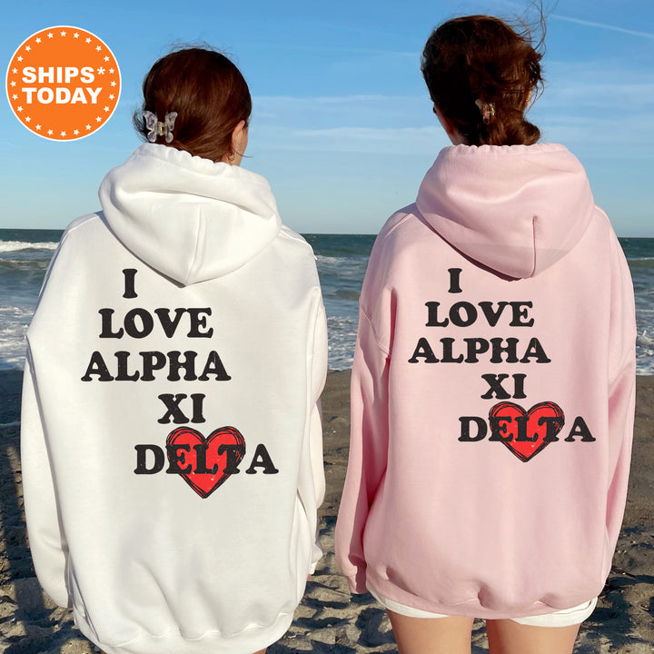 two women wearing matching sweatshirts on the beach