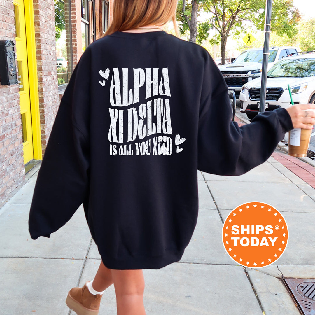 a woman walking down a sidewalk wearing a black sweatshirt