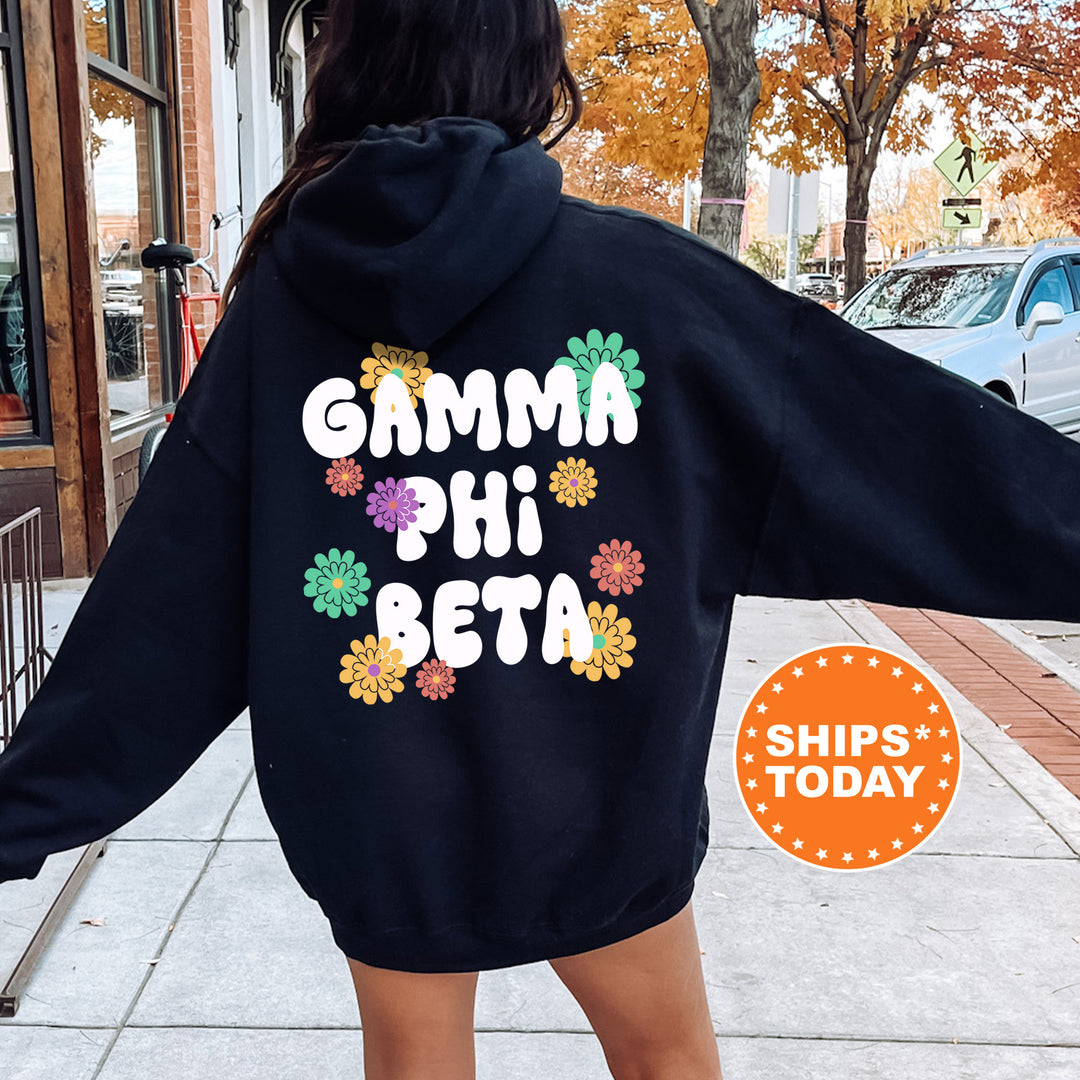 a woman wearing a black hoodie that says garma phi beta