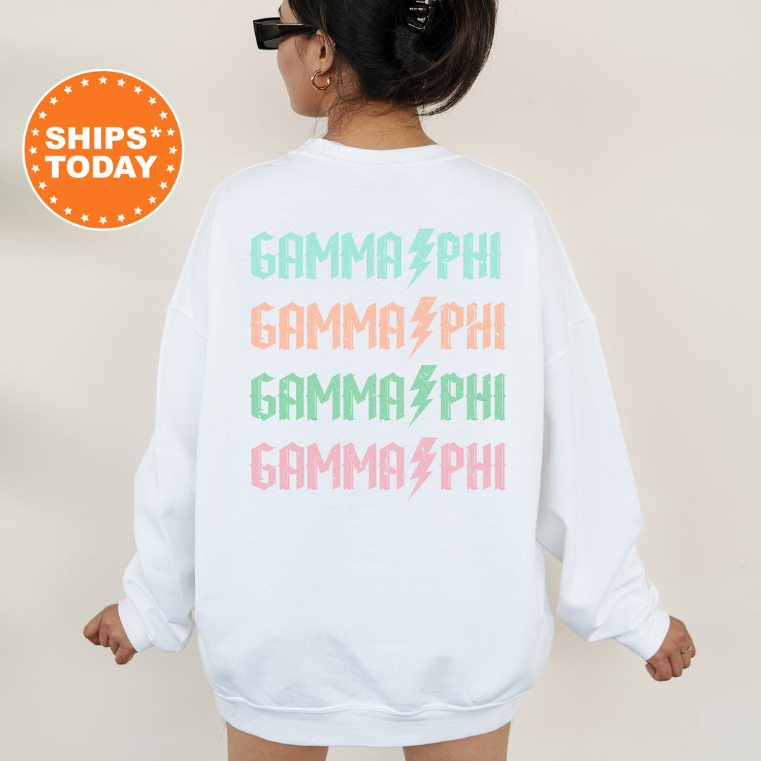 a woman wearing a white sweatshirt with the words gama phi on it