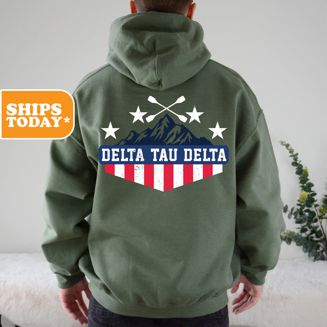 a man wearing a green hoodie with the words delta tau delta printed on it