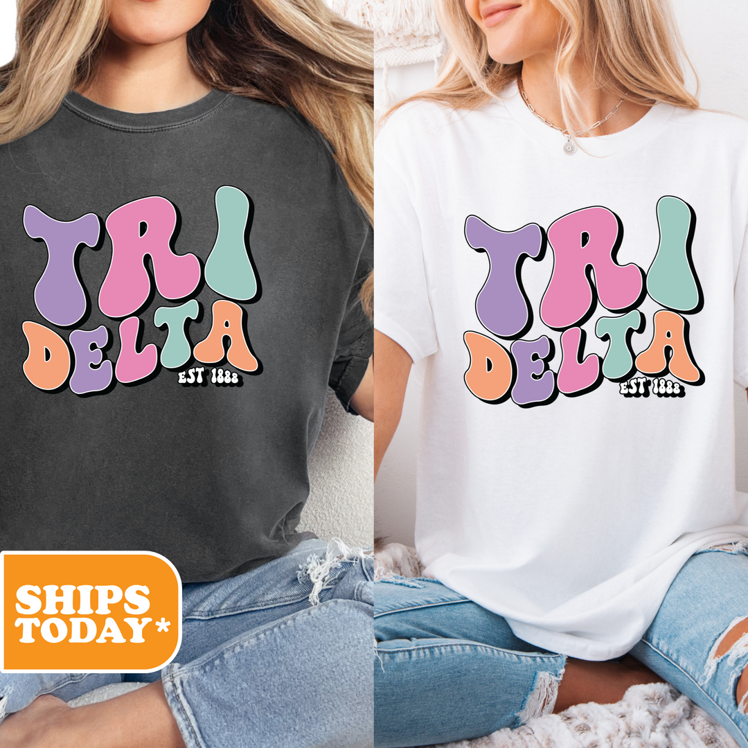 two women wearing matching tshirts with the words tri delta on them