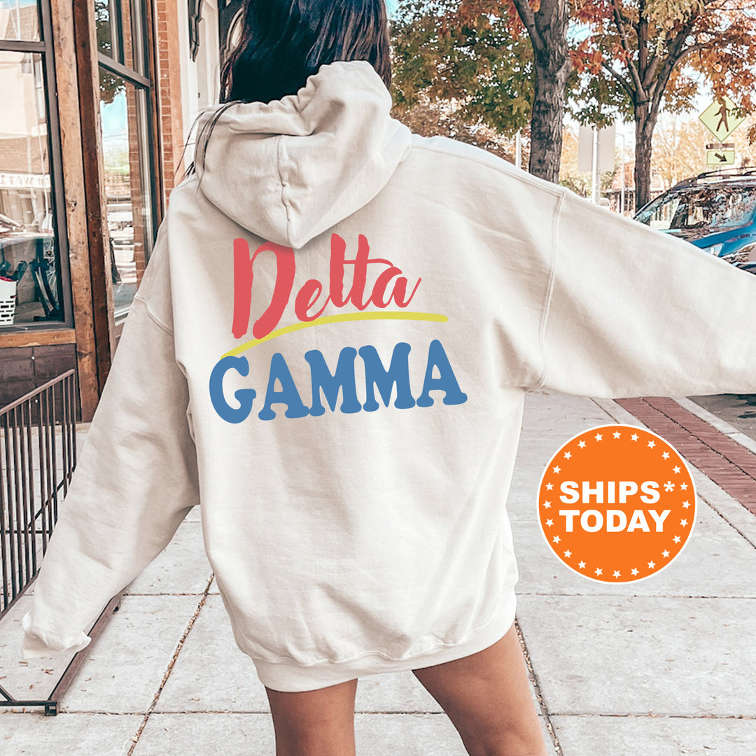 A person wearing a white hoodie with the Delta Gamma sorority logo on the back is standing on a sidewalk.